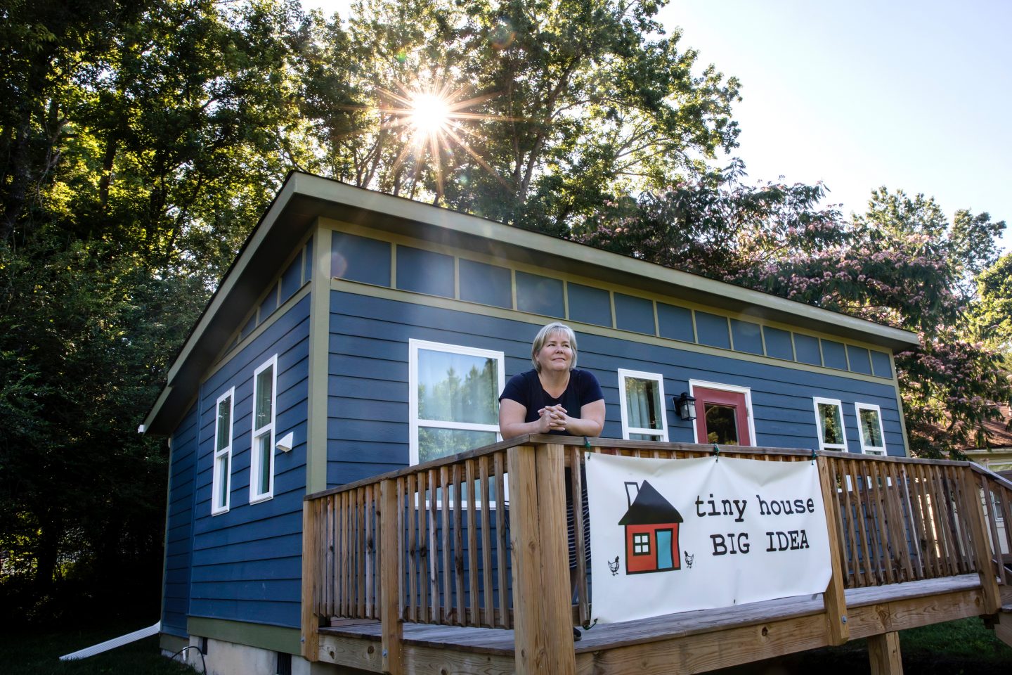Amy Blank Wilson, co-director of the Tiny Homes Village project and an associate professor and social work researcher at the School of Social Work, stands in front of the Tiny Homes Village model home.