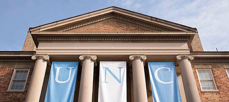 Partial view of South Building with hanging banners reading UNC