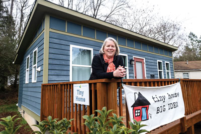 Amy Blank Wilson in front of Tiny Home model home.