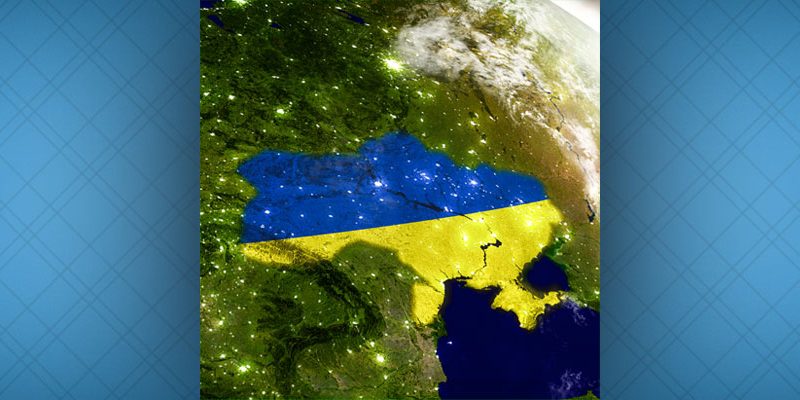 Ukraine with embedded flag on planet surface during sunrise. iStock 3D illustration with highly detailed realistic planet surface and visible city lights.