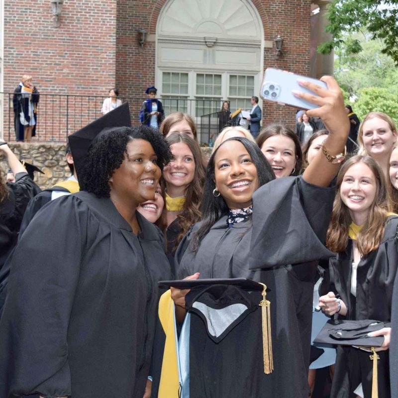 A group of MSW graduates taking a cell phone selfie.