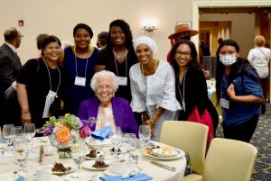 Students pose with Hortense McClinton at scholarship dinner.