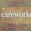 female hands gently cupped around male cupped hands beside the word CAREWORKER surrounded by a relevant word cloud on a rustic stone background
