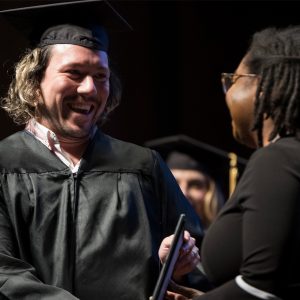 Clinical Assistant Professor Mauricio Yabar receives his award for Most Innovative Teaching Faculty during the May 13 commencement ceremony. 