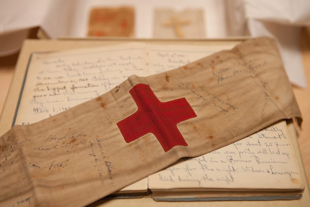 A museum display shows a diary and a medical band. Source: United States Holocaust Memorial Museum