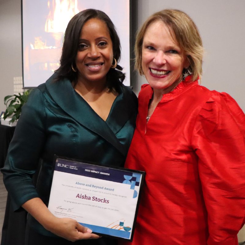 Aisha Stocks receives her Above and Beyond 2023 Staff Impact Award certificate from Kimberly Strom.